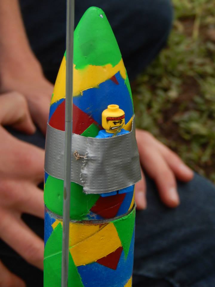 Lego man duct taped to the nosecone of a homemade model rocket